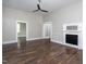 Inviting living area with hardwood floors, a ceiling fan, and decorative fireplace; seamlessly connected spaces at 704 Pender Street St, Rocky Mount, NC 27801