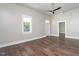 Open living space with hardwood floors, a ceiling fan, and plenty of natural light through large windows at 704 Pender St, Rocky Mount, NC 27801