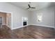 Spacious living room with hardwood floors, featuring a decorative fireplace and ample natural light at 704 Pender St, Rocky Mount, NC 27801