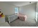 Inviting bedroom featuring a crib, neutral walls, and natural light creating a calming atmosphere at 768 Riguard Way, Wendell, NC 27591