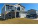 Charming two-story home featuring blue siding, brick accents, and an attached two-car garage at 768 Riguard Way, Wendell, NC 27591
