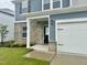 Home featuring blue siding, brick, a black front door, and an attached two-car garage at 768 Riguard Way, Wendell, NC 27591