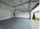 Spacious two-car garage featuring epoxy floors, providing secure parking and ample storage space at 768 Riguard Way, Wendell, NC 27591