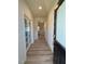 Inviting hallway with wood floors, leading to a living area, with elegant French doors to the left at 768 Riguard Way, Wendell, NC 27591