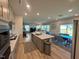 Open-concept kitchen with island seating and dining area, perfect for gatherings and entertaining at 768 Riguard Way, Wendell, NC 27591