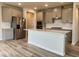 Modern kitchen featuring stainless steel appliances, white countertops, and shaker cabinets at 768 Riguard Way, Wendell, NC 27591