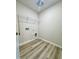 Functional laundry room with wood-look flooring and shelving, providing efficient space for chores at 768 Riguard Way, Wendell, NC 27591