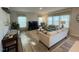 Bright and airy living room with large windows, cozy seating, and decorative rug at 768 Riguard Way, Wendell, NC 27591