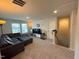 Upper level living room with a comfortable sectional couch and neutral colored walls and carpeting at 768 Riguard Way, Wendell, NC 27591