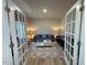 Elegant living room with stylish sofas, a modern coffee table, and French door entry at 768 Riguard Way, Wendell, NC 27591