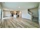 Open living space with wood-look flooring, seamlessly flowing into a kitchen with an island at 768 Riguard Way, Wendell, NC 27591