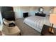 Comfortable main bedroom that includes sitting area with two cushioned chairs at 768 Riguard Way, Wendell, NC 27591