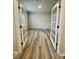 Inviting office space featuring wood-look flooring and elegant glass paneled double doors at 768 Riguard Way, Wendell, NC 27591