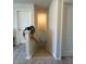 Carpeted stairway leading upstairs, featuring white trim, and a small decorative plant at 768 Riguard Way, Wendell, NC 27591