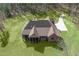 Stunning aerial view of a brick home with screened porch and a long driveway surrounded by lush greenery at 7936 Nc 42, Holly Springs, NC 27540