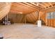 Unfinished attic area with exposed beams, subfloor, and natural light at 7936 Nc 42, Holly Springs, NC 27540