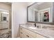 Bathroom featuring granite countertop, undermount sink, and framed mirror at 7936 Nc 42, Holly Springs, NC 27540