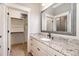 Bathroom featuring granite countertop, undermount sink, and walk in closet at 7936 Nc 42, Holly Springs, NC 27540