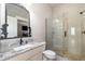 Bathroom featuring granite countertop, undermount sink, and frameless glass shower at 7936 Nc 42, Holly Springs, NC 27540