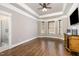 Bedroom with trey ceiling, hardwood floors, natural light and bathroom entrance at 7936 Nc 42, Holly Springs, NC 27540