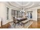 Dining area featuring a chandelier, large windows, and wood dining table with seating at 7936 Nc 42, Holly Springs, NC 27540