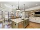 Gourmet kitchen features granite counters, large island, stainless appliances, and hardwood floors at 7936 Nc 42, Holly Springs, NC 27540