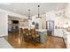 Bright kitchen with a center island, white cabinetry, and stainless steel appliances at 7936 Nc 42, Holly Springs, NC 27540