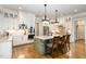 Charming kitchen with white cabinets, stainless steel appliances, and an island with seating at 7936 Nc 42, Holly Springs, NC 27540