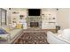 Comfortable living room with stone fireplace, built in shelving, and hardwood floors at 7936 Nc 42, Holly Springs, NC 27540