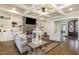 Inviting living room with coffered ceiling, stone fireplace, and built in shelving at 7936 Nc 42, Holly Springs, NC 27540