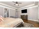 Spacious main bedroom with hardwood floors, tray ceiling, and ensuite at 7936 Nc 42, Holly Springs, NC 27540