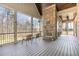 Covered porch with stone fireplace, wood ceiling, and outdoor seating, great for relaxing at 7936 Nc 42, Holly Springs, NC 27540