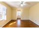 Bright bedroom featuring hardwood floors, a ceiling fan, and ample sunlight at 8700 Hebron Church Rd, Mebane, NC 27302