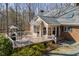 Exterior rear view of home, showcasing a large deck and backyard at 8700 Hebron Church Rd, Mebane, NC 27302