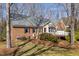 Back exterior of the home showing the deck, brick, and siding at 8700 Hebron Church Rd, Mebane, NC 27302