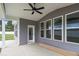 Covered back porch with ceiling fan and multiple windows for ample light at 9173 Dupree Meadow Ct # 25, Angier, NC 27501