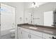 Bathroom with tiled shower, vanity with dark countertop, and white cabinets at 9173 Dupree Meadow Ct # 25, Angier, NC 27501