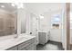 Bathroom with double sink vanity, tiled shower, and patterned floor tiles at 9173 Dupree Meadow Ct # 25, Angier, NC 27501