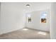 Empty room with carpet, base molding, two windows, and natural light at 9173 Dupree Meadow Ct # 25, Angier, NC 27501