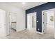 A bedroom with a blue accent wall showcasing open doorways to other rooms at 9173 Dupree Meadow Ct # 25, Angier, NC 27501