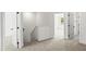 Hallway with neutral carpet, white walls, and doors leading to other rooms at 9173 Dupree Meadow Ct # 25, Angier, NC 27501