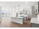 Modern kitchen with an island, pendant lighting, and stainless steel appliances at 9173 Dupree Meadow Ct # 25, Angier, NC 27501
