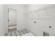 A laundry room with wire shelving and patterned tile floor at 9173 Dupree Meadow Ct # 25, Angier, NC 27501