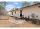 A charming backyard featuring an outdoor patio, chairs, and access to the home with a small yard enclosed with a chain-link fence at 92 Papoose Trl, Lillington, NC 27546