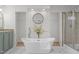 Bright bathroom featuring a free-standing tub, a shower, and a double vanity with granite countertop at 92 Papoose Trl, Lillington, NC 27546