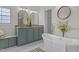 Bright bathroom featuring a free-standing tub, a shower, and a double vanity with granite countertop at 92 Papoose Trl, Lillington, NC 27546