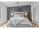 Inviting bedroom with stylish accent wall, comfortable bed, decorative lamps, and a peaceful ambiance at 92 Papoose Trl, Lillington, NC 27546