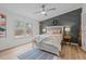 Serene bedroom featuring an accent wall, plush bedding, and ample natural light from the windows at 92 Papoose Trl, Lillington, NC 27546
