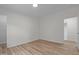 Clean bedroom featuring wood-look flooring, a neutral color palette, and ensuite bathroom at 92 Papoose Trl, Lillington, NC 27546