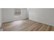 Bright bedroom featuring wood-look flooring, a neutral color palette, and natural light at 92 Papoose Trl, Lillington, NC 27546